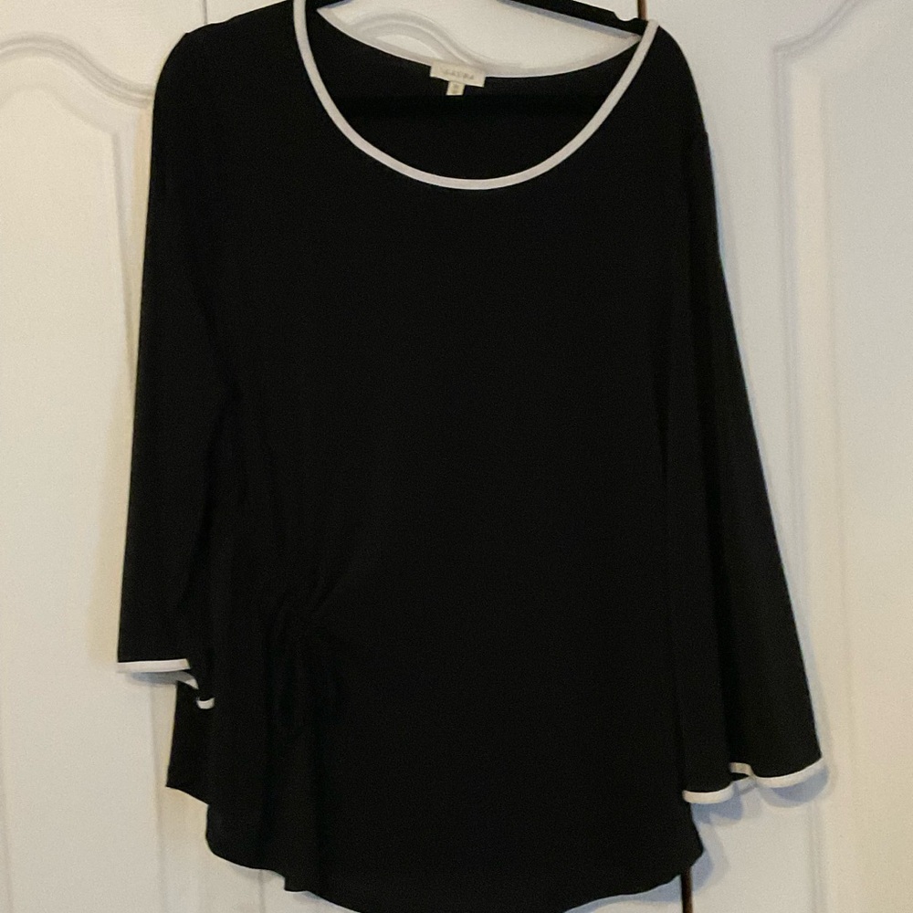Black top with white accents. Decorative tie .